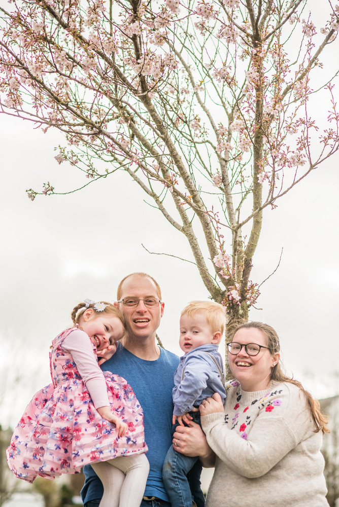 Posing by a blossom tree, newborn photographer Cockermouth