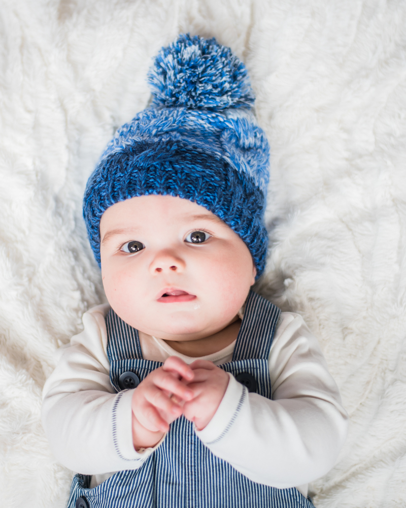Lying with hat on - baby photographer Carlisle