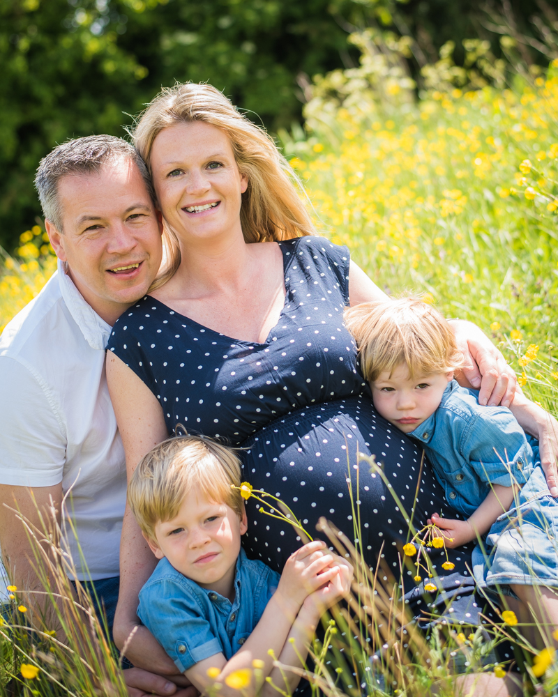 Family snuggles in buttercups, newborn photographer Carlisle