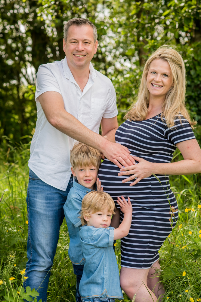 Smiling family portrait in sunshine, Cockermouth baby photographer