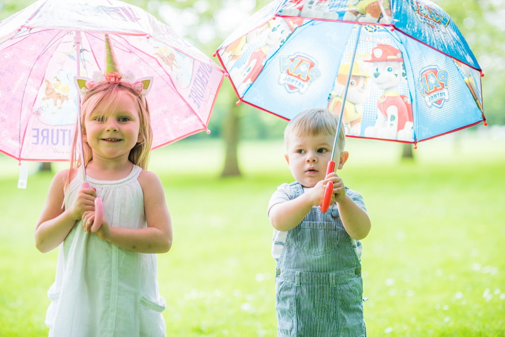 Katie and Freddie with umbrellas, Carlisle baby photographers