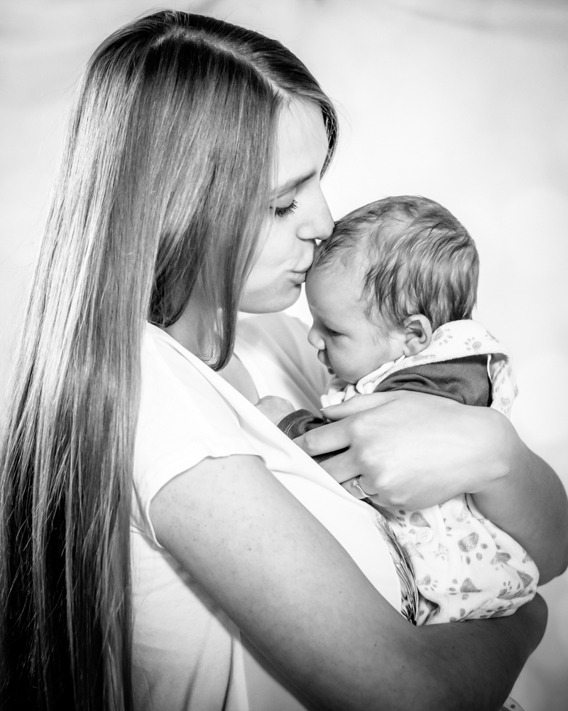 Mum kissing baby Adam, newborn photographers Carlisle