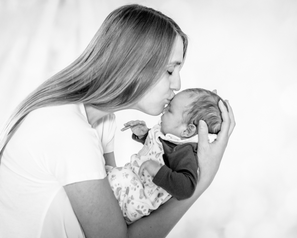 Mum kissing baby on head, Cockermouth baby photographers