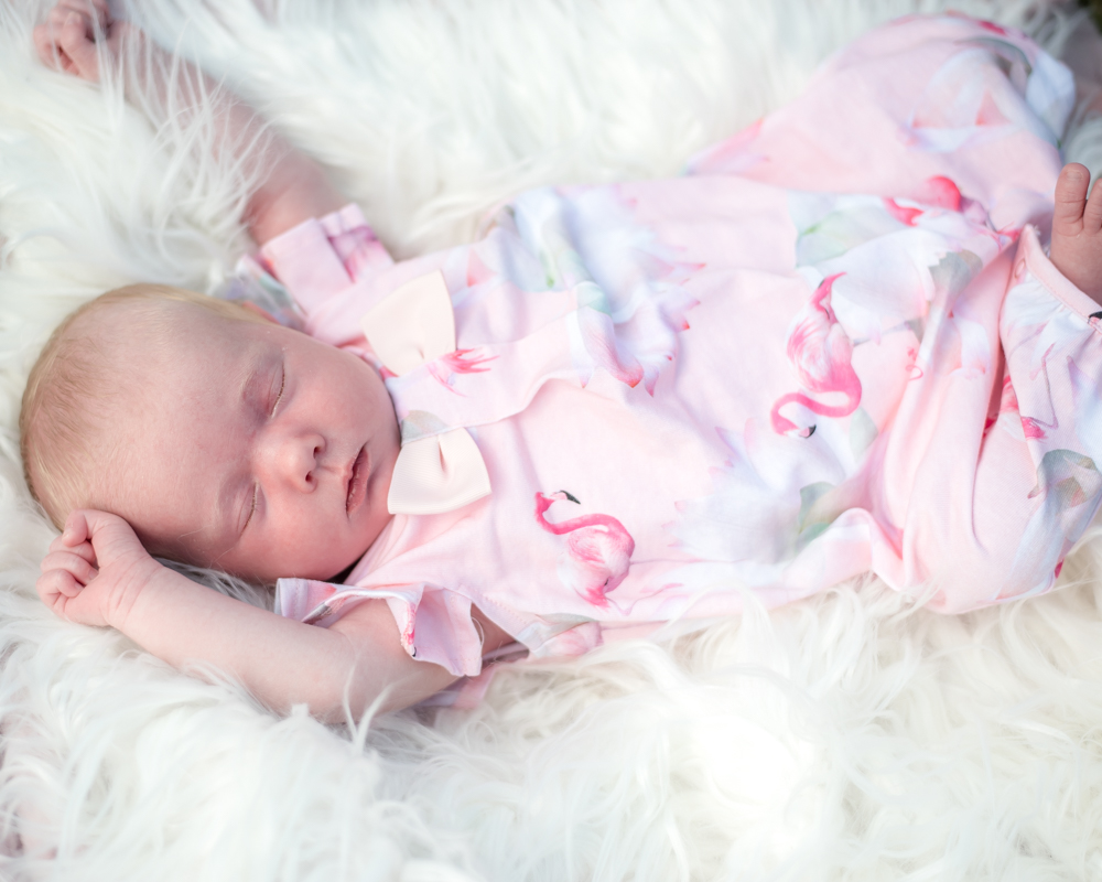 Tiny Beatrix lying on fluffy rug, newborn portraits Carlisle