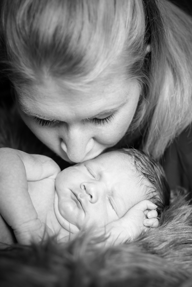 Mum kissing baby Oliver, newborn portraits Carlisle