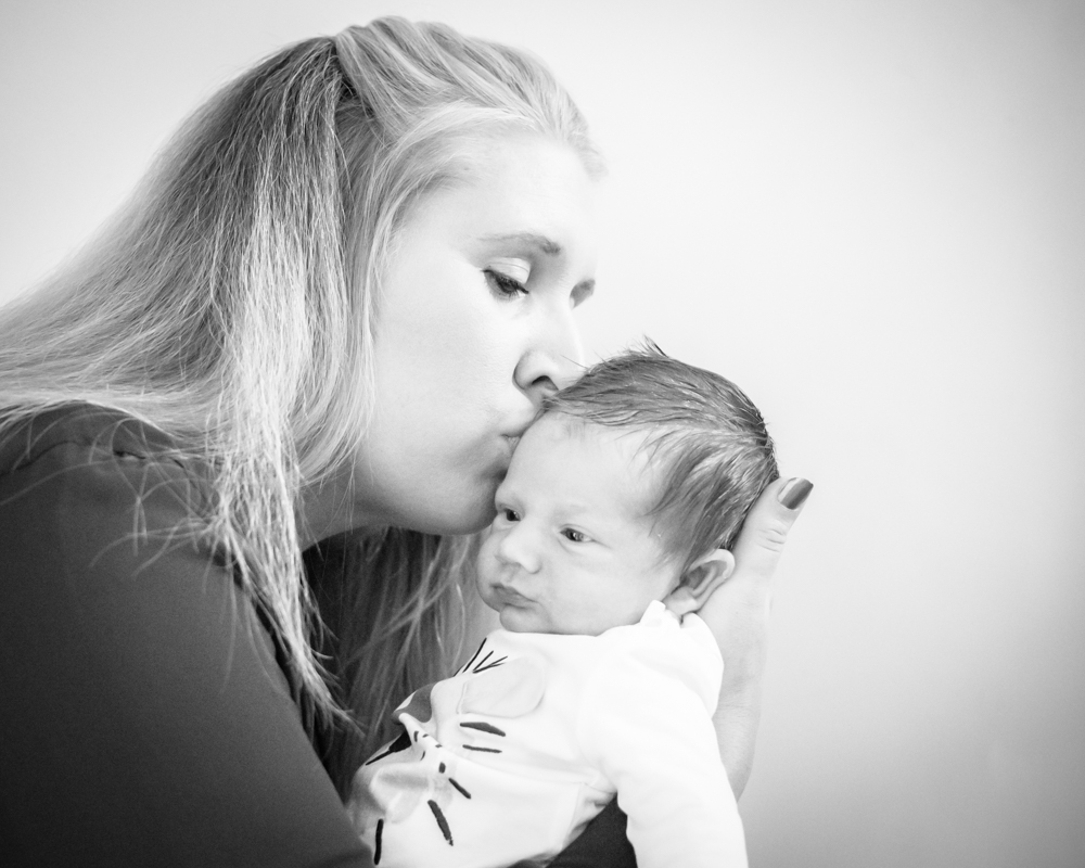 Mum kissing baby on head, newborn portraits Cockermouth
