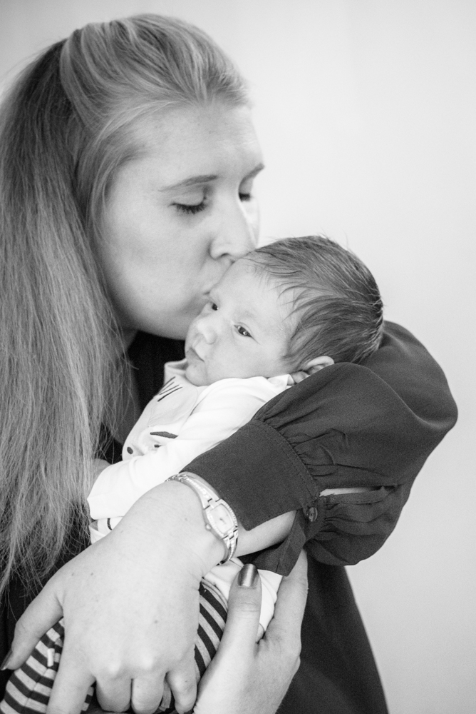 Mum kissing baby, natural newborn photographs