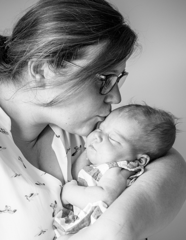 Mum kissing baby on head, newborn photographers