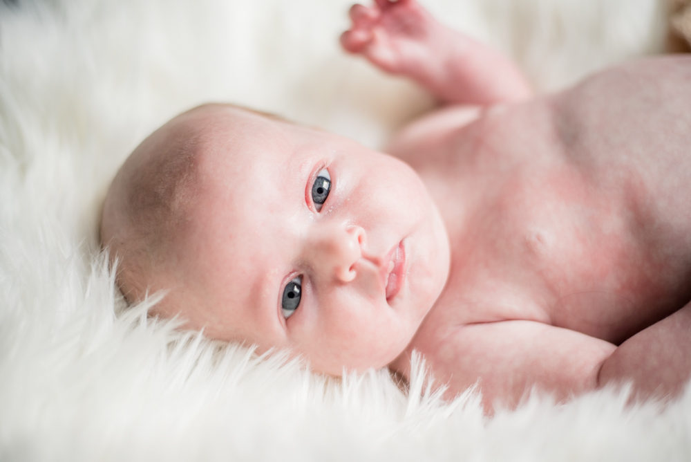Baby waving to camera, newborn portraits Wigton