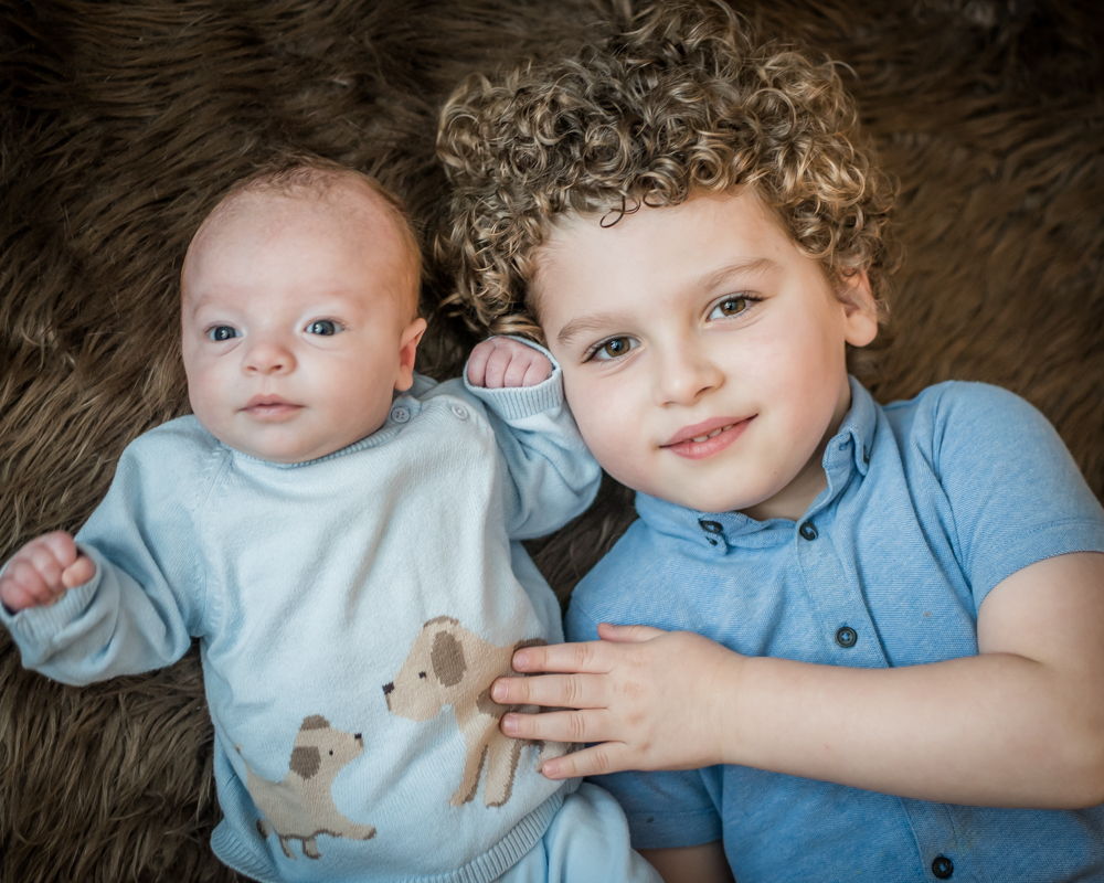 Cuddles with brother, newborn photographer Keswick