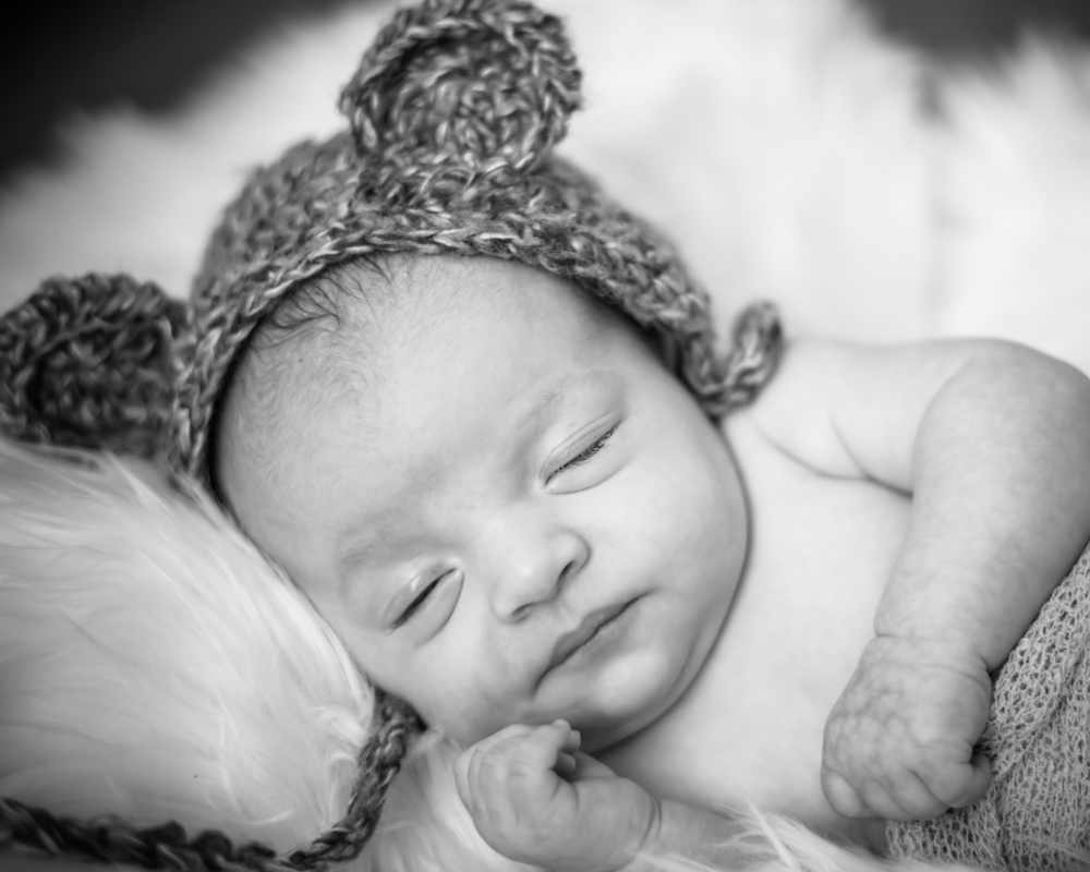 Sleepy baby Toby and cuddly hat, newborn photographers Keswick
